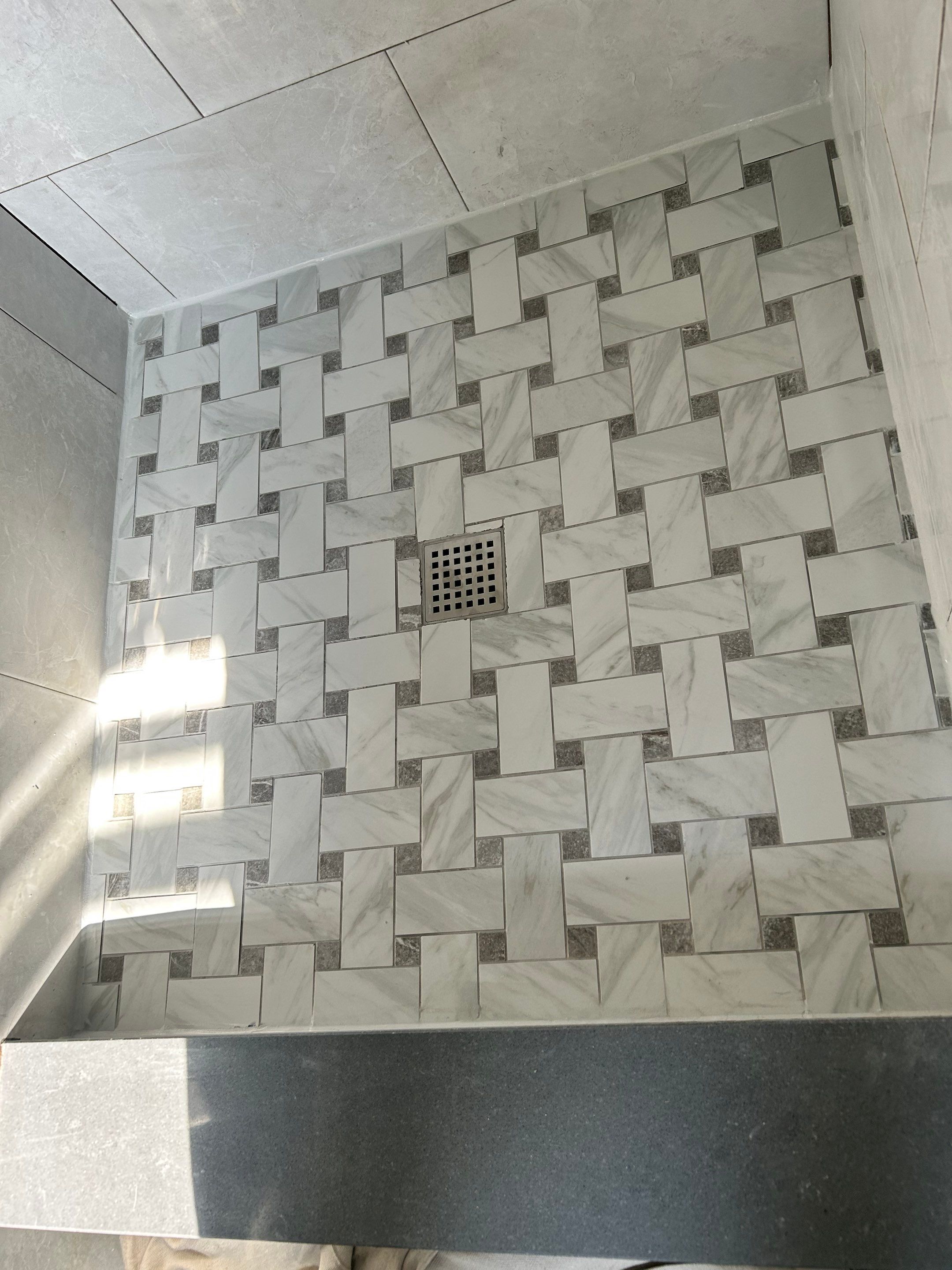 Custom shower floor detail by Elixtro Renovations